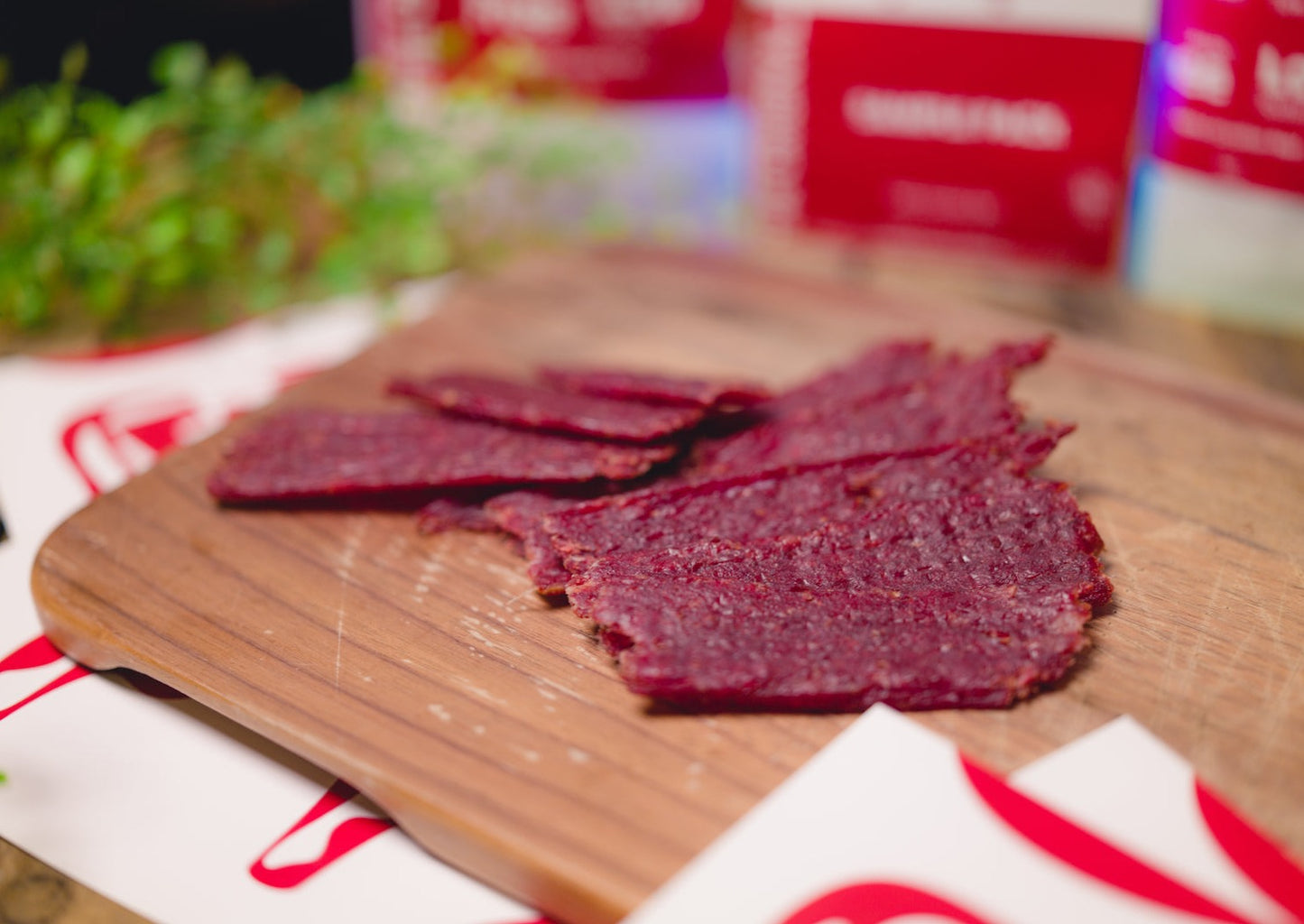 Pieces of a beef jerky meat snack on a board.